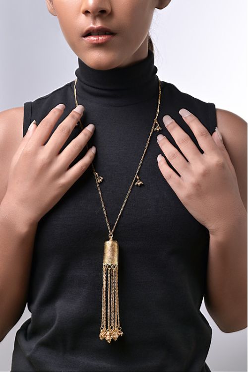 Women wearing brass pendant necklace