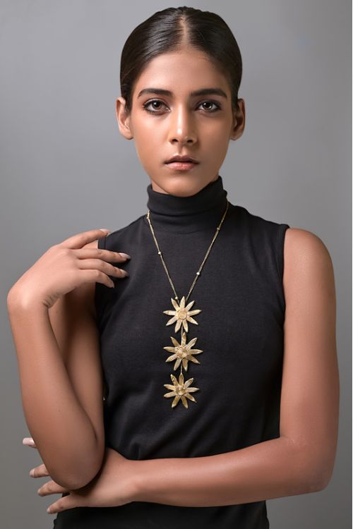 women wearing flower brass necklace