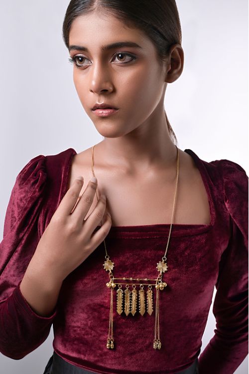 Women wearing brass necklace