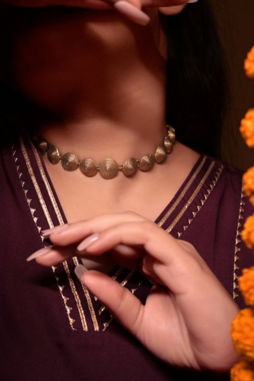 Women wearing brass choker